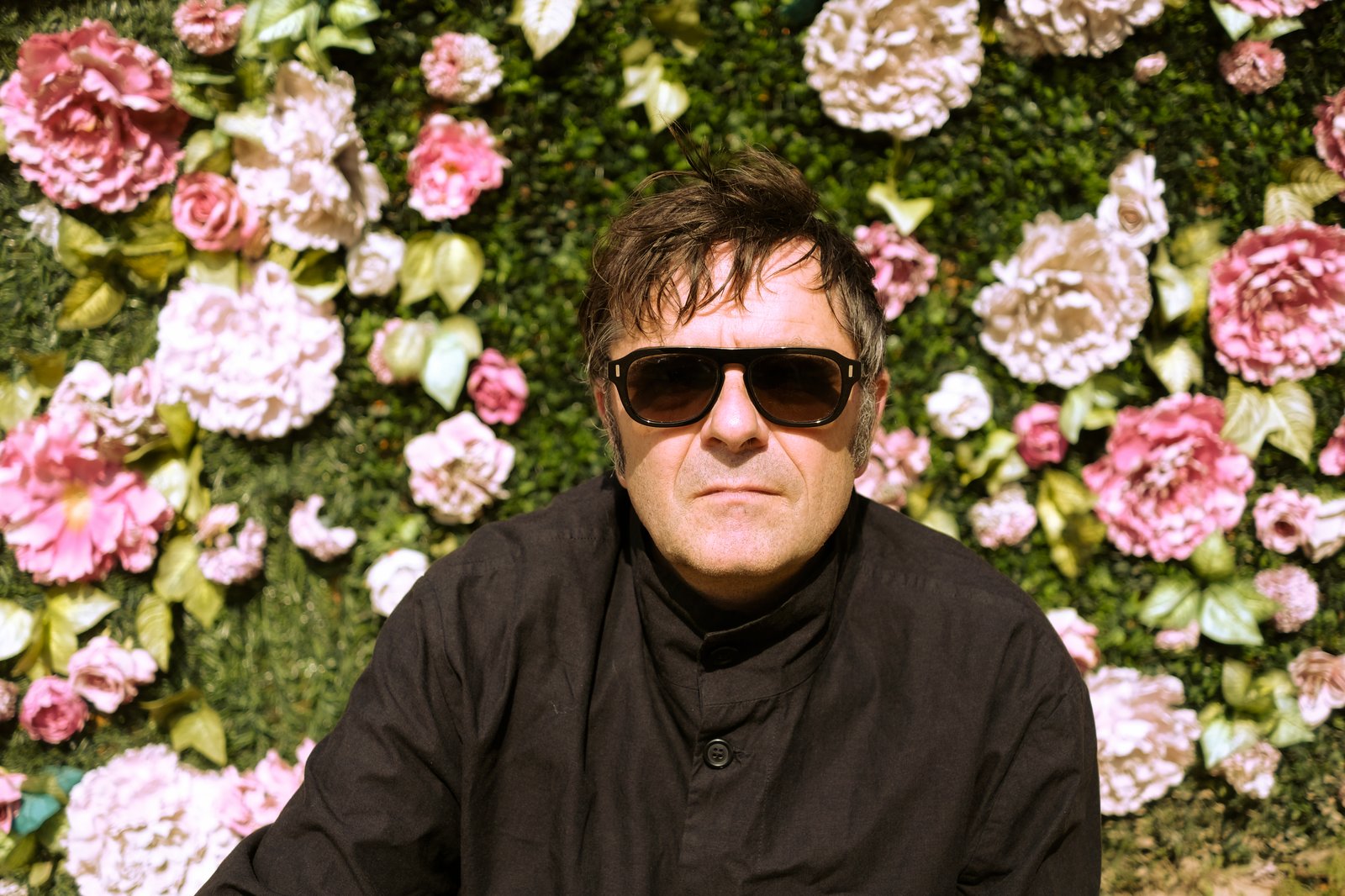 Künstler Christoph Schäfer vor einer Blumenwand in Kasnevitz