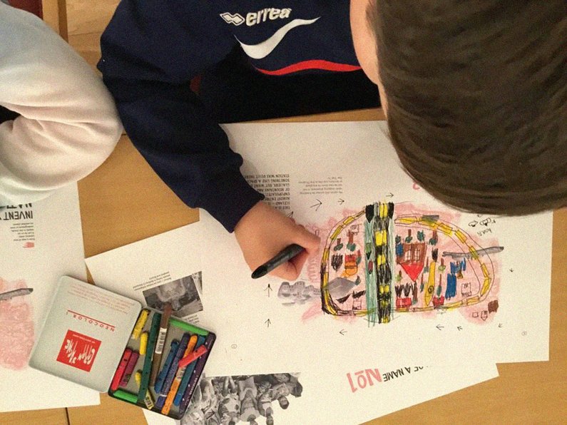 View from above of a child drawing a colourful picture