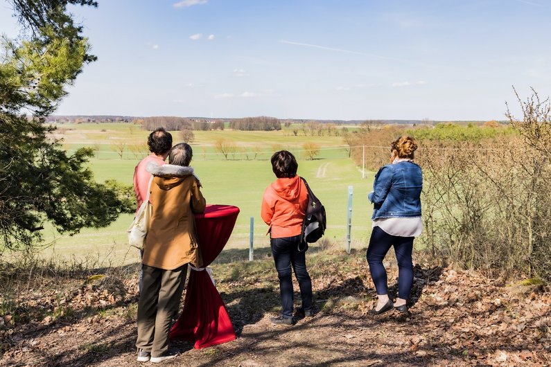 Members of The New Patrons and the view of the Friedland landscape