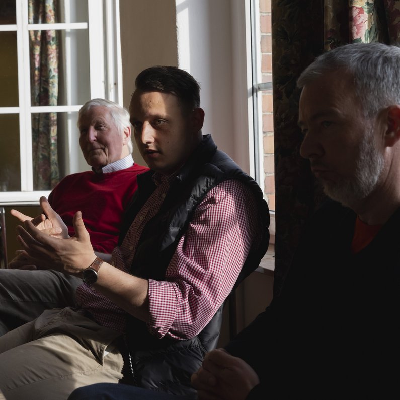 Three people from the New Patrons of Sauen discussing