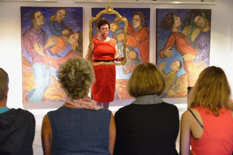 Residents of Pritzwalk sit in front of a lecturer in an exhibition