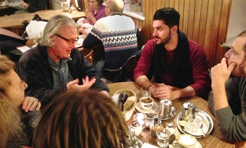 Bruce Sterling, Sartep Namiq and the team of the New Patrons of Tempelhof sit at the table, talking