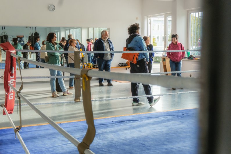 A group is standing in a dance studio.
