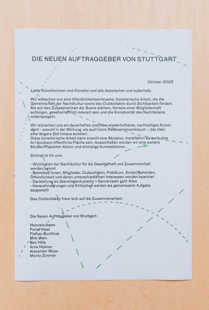 A paper contract lies on a wooden surface