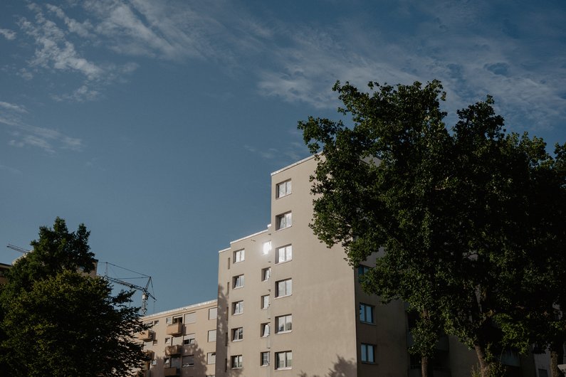 Row of houses with trees, blue sky